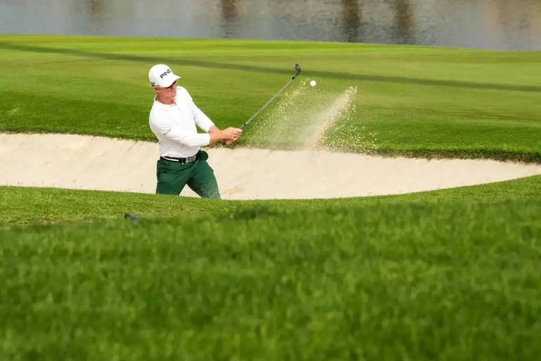 a-golfer-skillfully-hitting-a-ball-from-a-sand-trap-on-a-bright-sunny-day-showcasing-sporting-technique